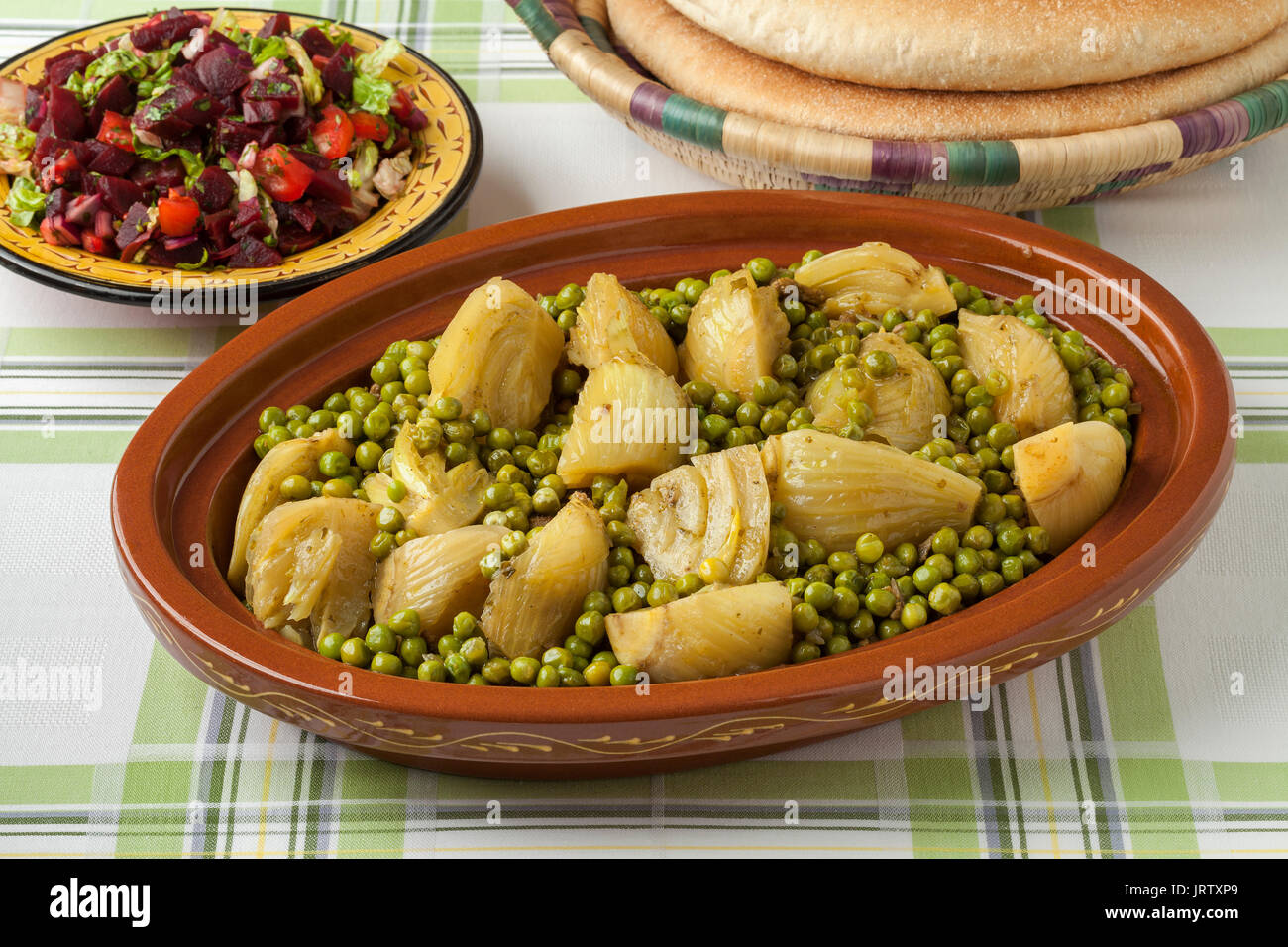 Traditionelle marokkanische Tajine mit Fleisch, Erbsen, Fenchel, Rote Bete, Salat und Brot Stockfoto