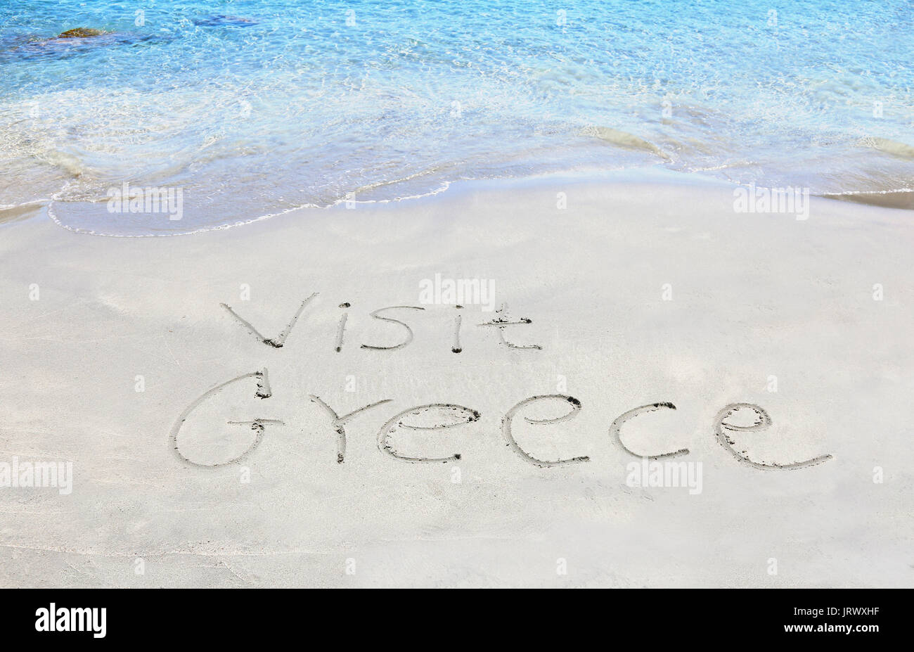 Besuchen sie Griechenland auf Sand geschrieben - griechische Sommer Fotos Stockfoto