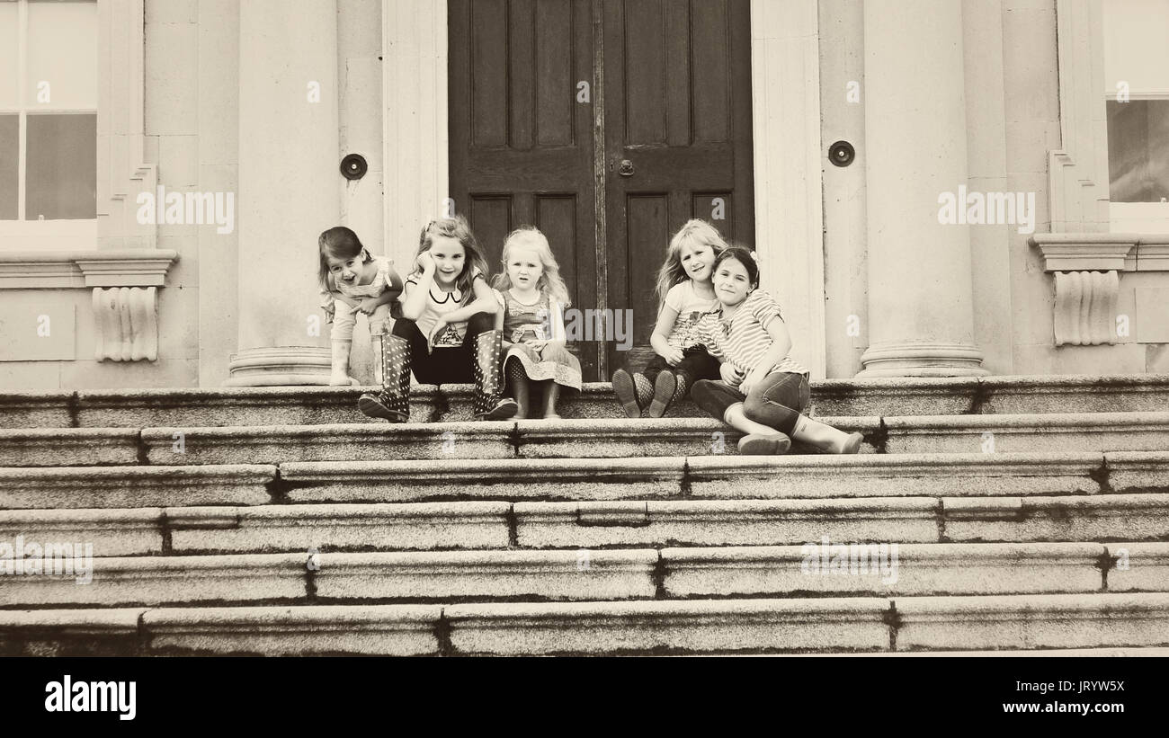 Fünf kleine Mädchen, Kinder sitzen auf den Stufen von Castletown House, Celbridge, Co Kildare Stockfoto
