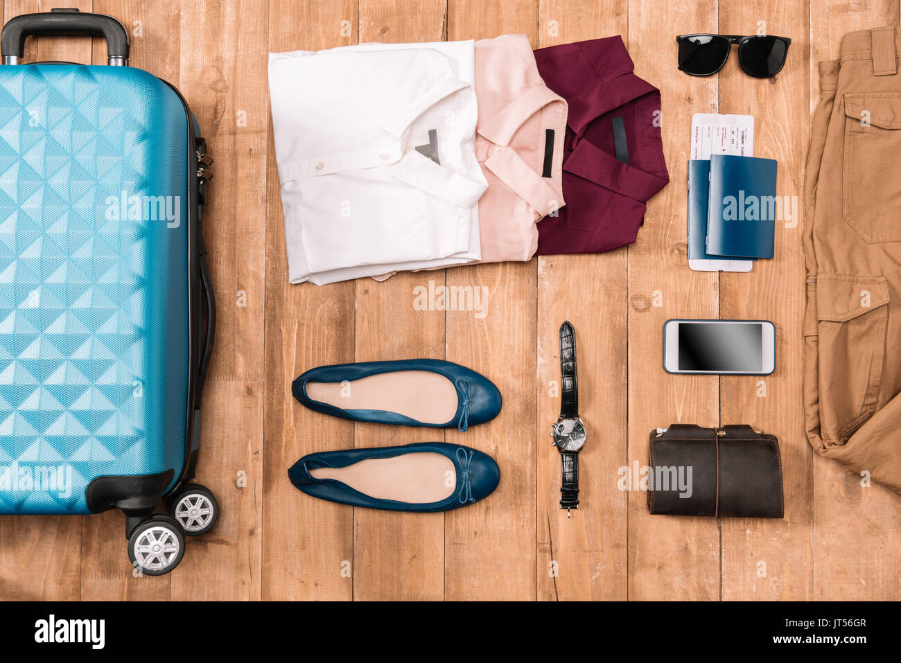 Flay lay von Business Urlaub Konzept mit Kleidung, digitale Gadgets, Reisepass und Tickets auf Holzboden. Stockfoto