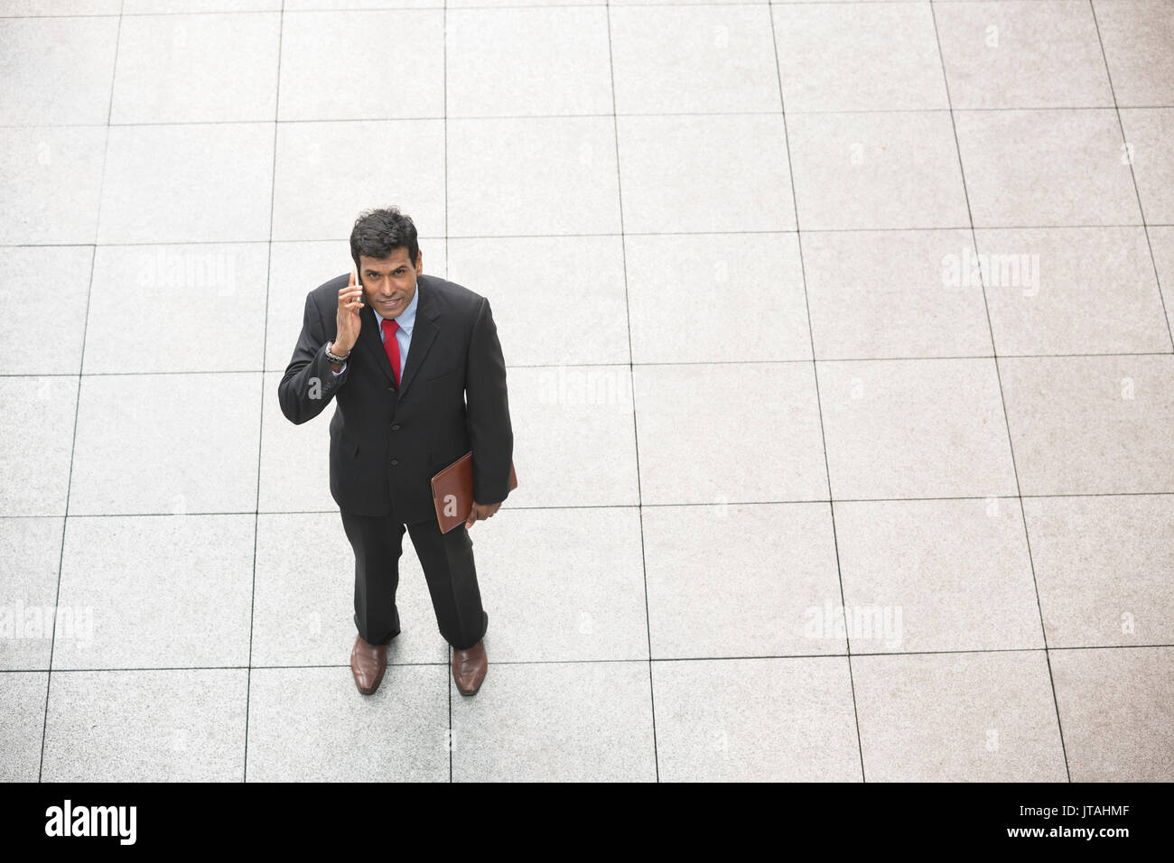 Ansicht eines indischen Geschäftsmann mit seinem Smart Phone. Stockfoto