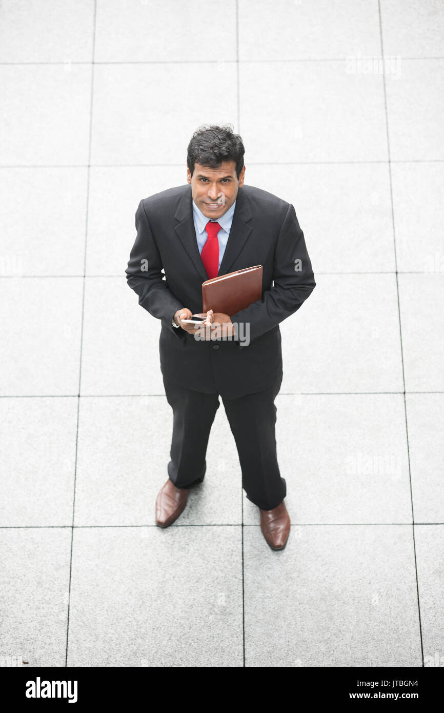 Ansicht eines indischen Geschäftsmann mit seinem Smart Phone. Stockfoto