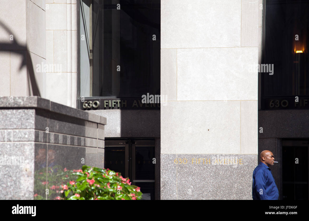 Mann, der Zigarettenpause außerhalb des Gebäudes in New York - USA Stockfoto