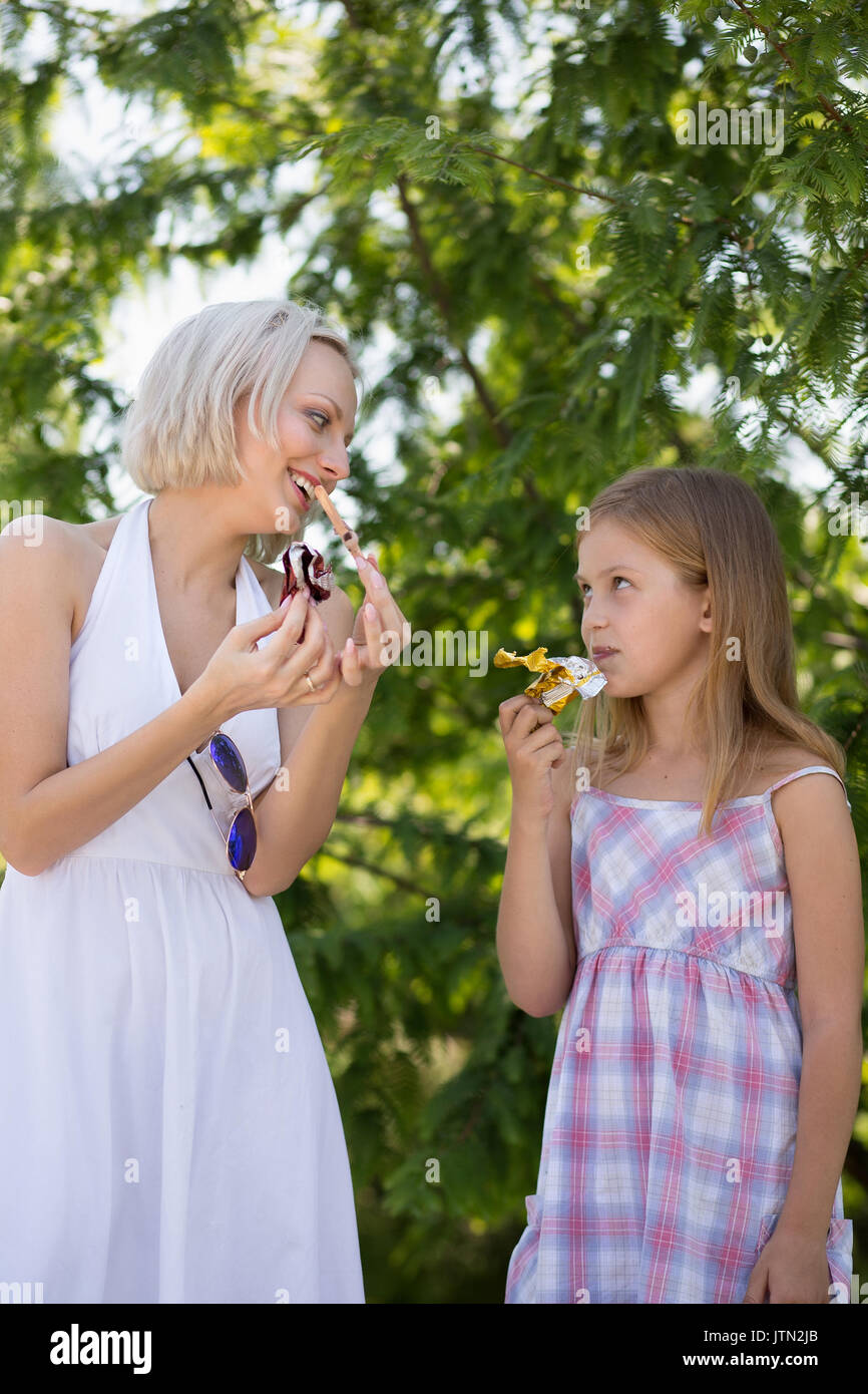 Glückliche Momente, Mutter und Tochter im Park essen Eis. Stockfoto