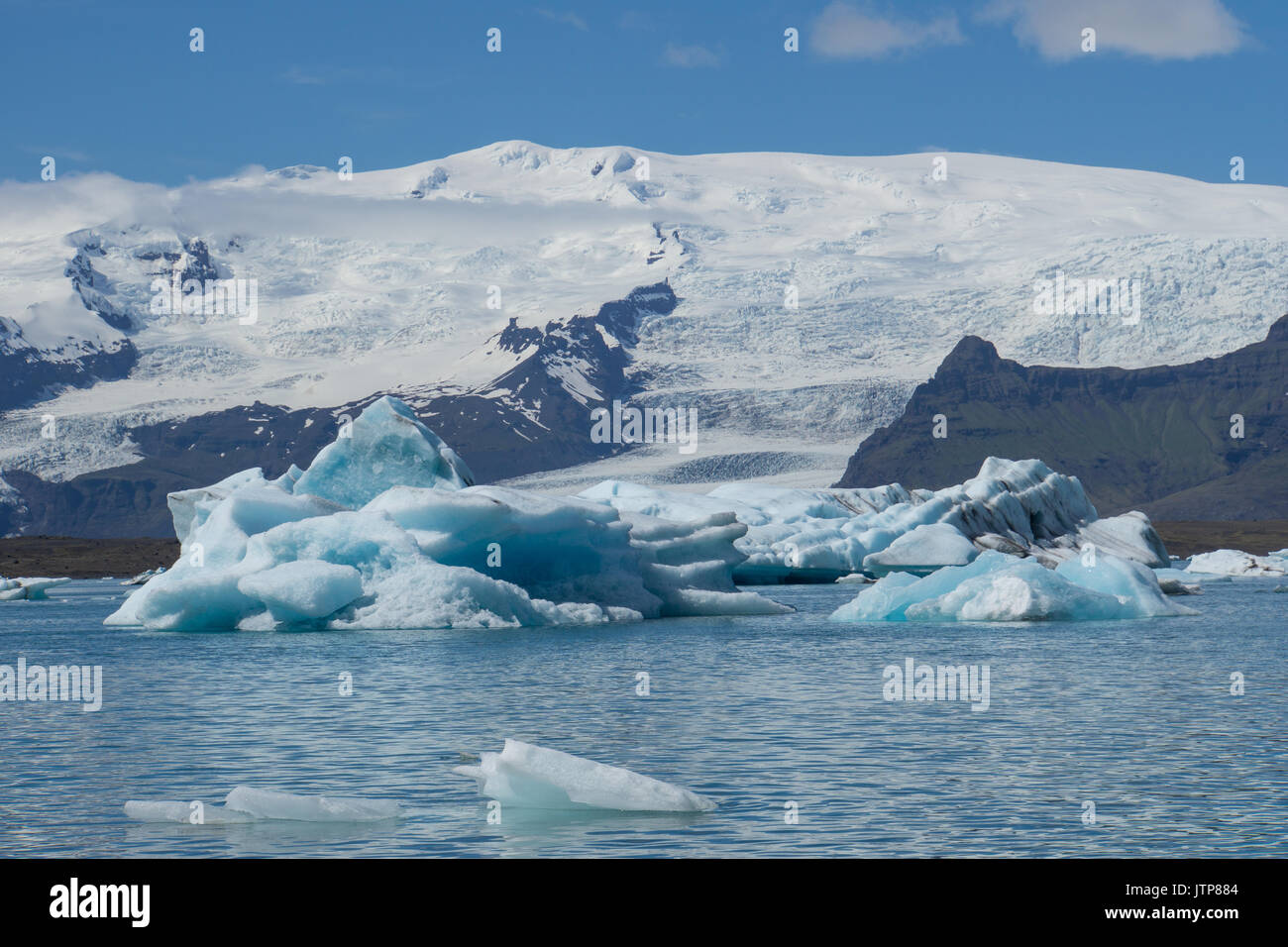 Island - Riesige türkis leuchtenden Eisberge in den Gletschersee vor massiven Gletscher vatnajoekull Stockfoto