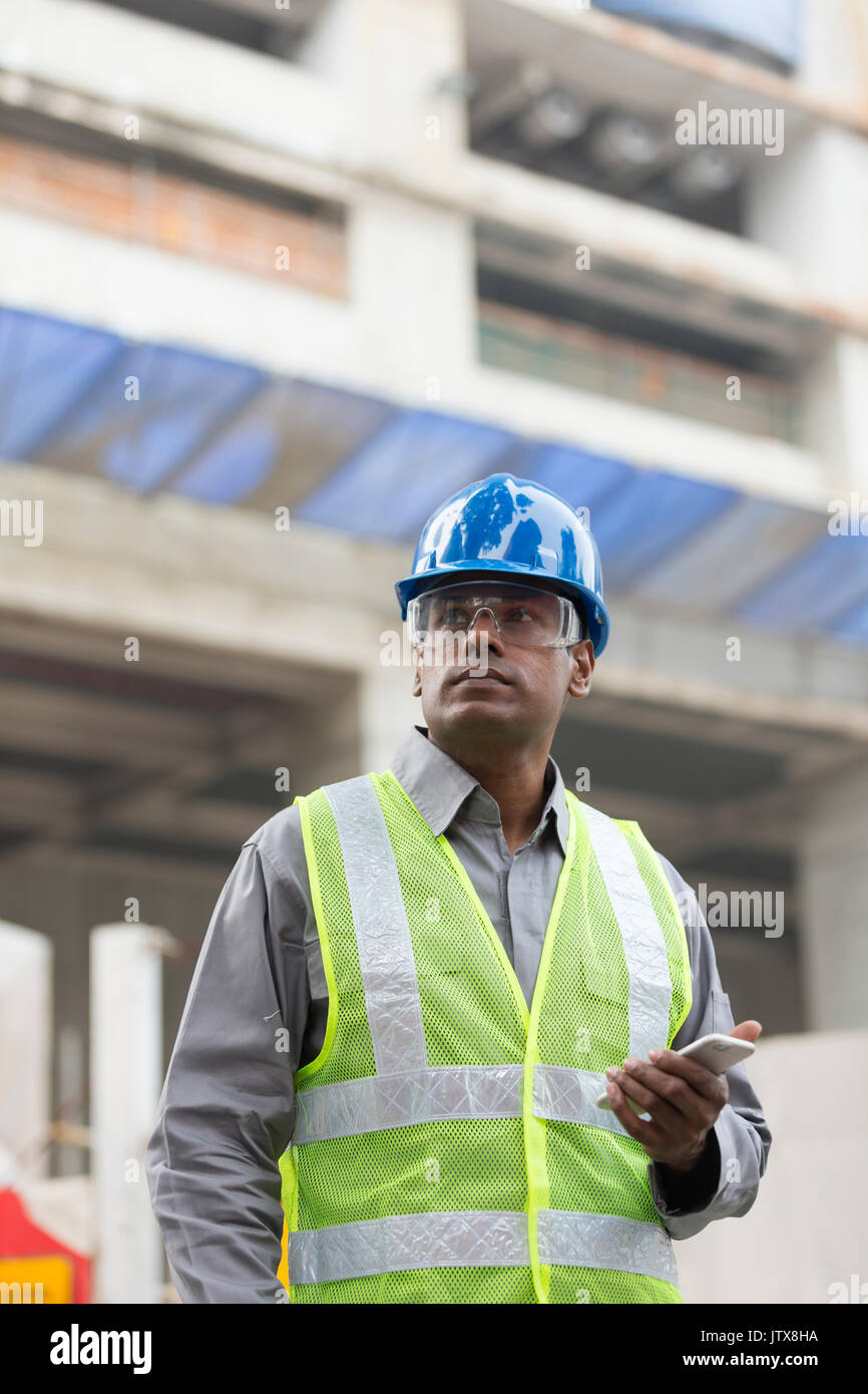 Porträt einer männlichen Indischen Wirtschaftsingenieur oder Erbauer bei der Arbeit. Stockfoto