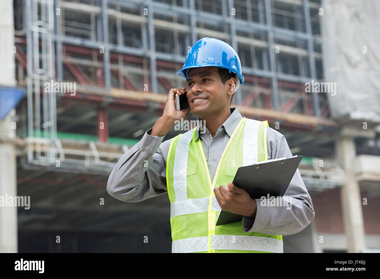 Porträt einer männlichen Indischen Builder oder Wirtschaftsingenieur mit Telefon. Stockfoto