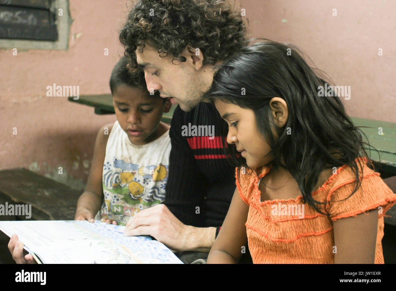 Ein freiwilliger eine Geschichte liest, um arme Kinder, Tucuman, Argentinien, Südamerika Stockfoto