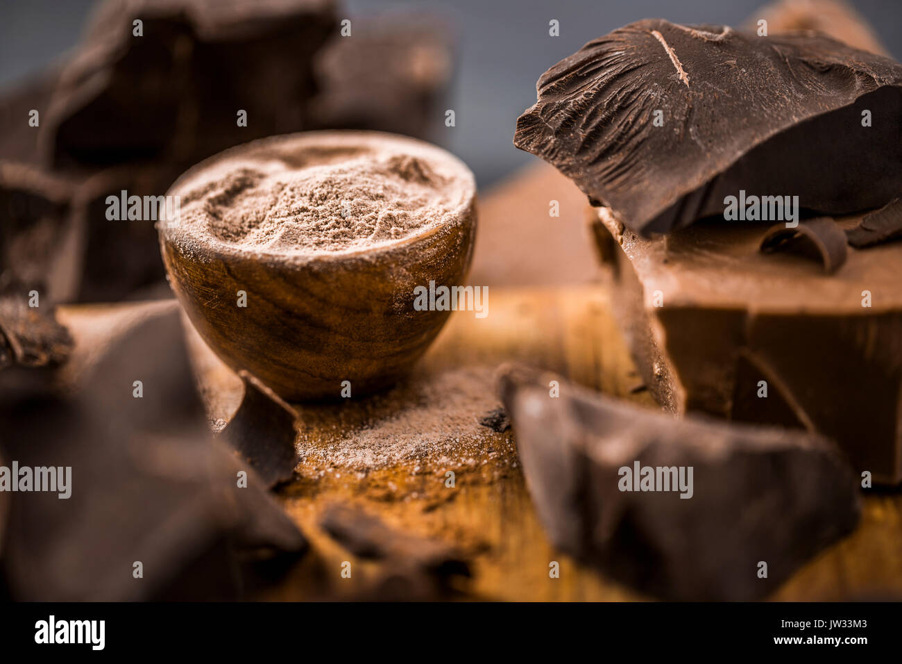Boden Schokolade in Houten neben Klumpen der Schokolade Stockfoto