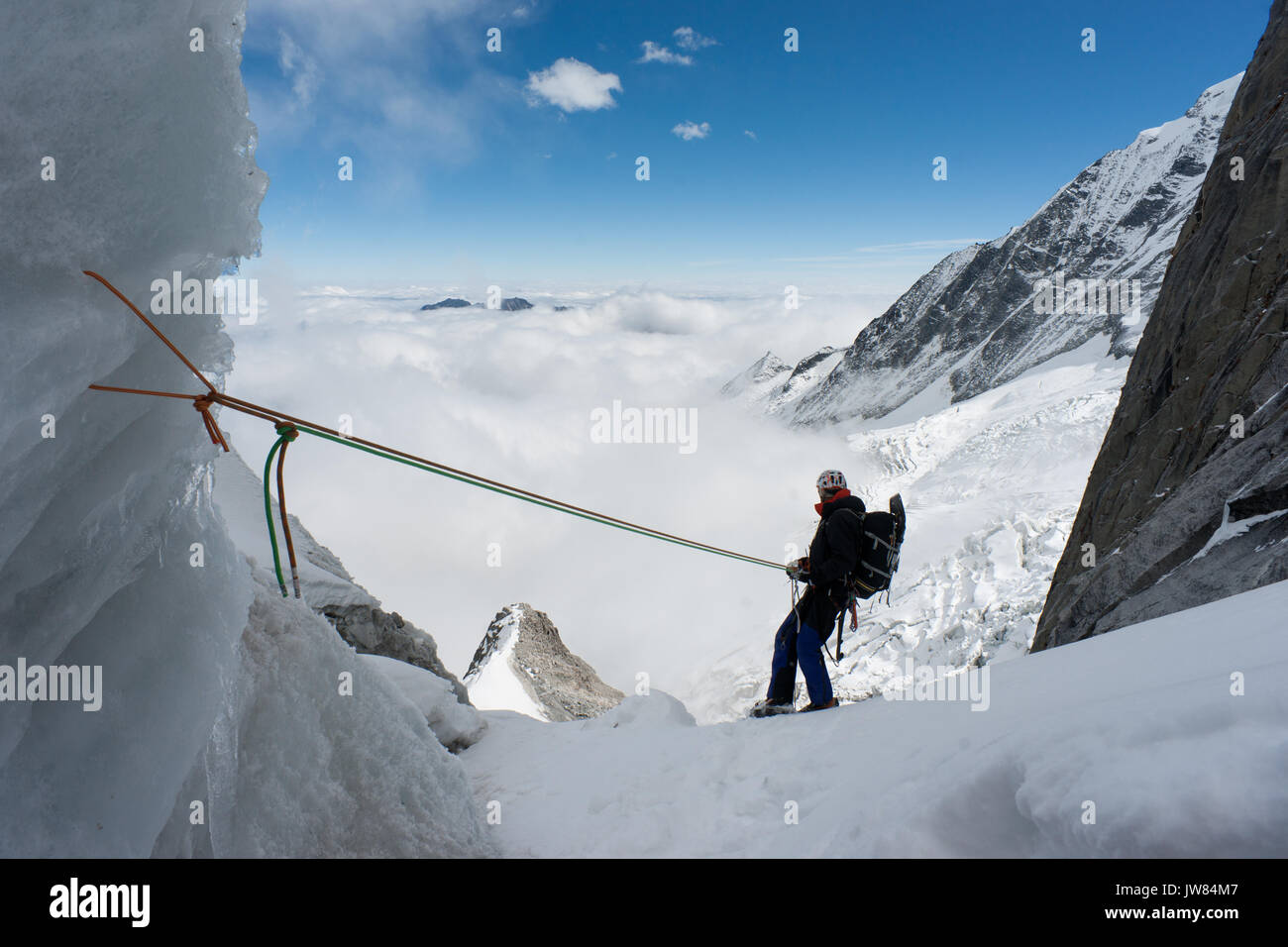 Ansicht der Rückseite des Alpinisten nach unten Abseilen in San Lian Südosten. Am frühen Morgen in den Minya Konka massiv, daxue in westlichen Sichuan in der Nähe von Tibet. China. Asien Stockfoto