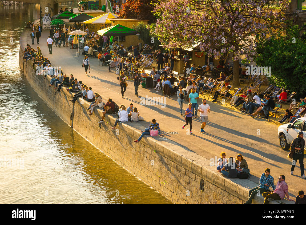 Wiener Grachtensommer, Blick auf den Donaukanal im Wiener Schwedenplatz, ein beliebter Ort zum Entspannen in den Sommermonaten. Stockfoto