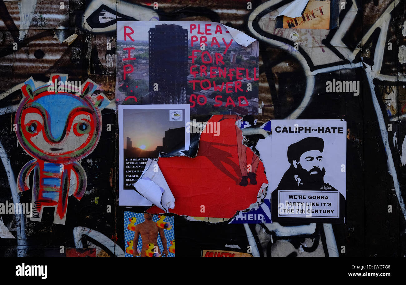 Ein Poster zum Ausdruck Trauer für die Opfer von Grenfell Turm unter den Graffiti an einer Wand in der Brick Lane, im East End von London Stockfoto