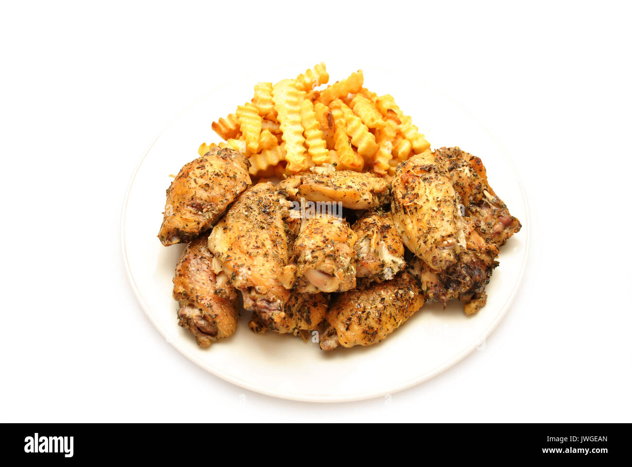 Italienisch gewürzt serviert mit Pommes Frites Chicken Wings Stockfoto