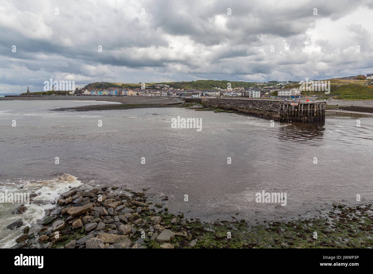 Blick über den Fluss Ystwyth zum Hafen Wellenbrecher und Aberystwyth South Beach. Die Reste des alten Schlosses können am Ende von t gesehen werden. Stockfoto
