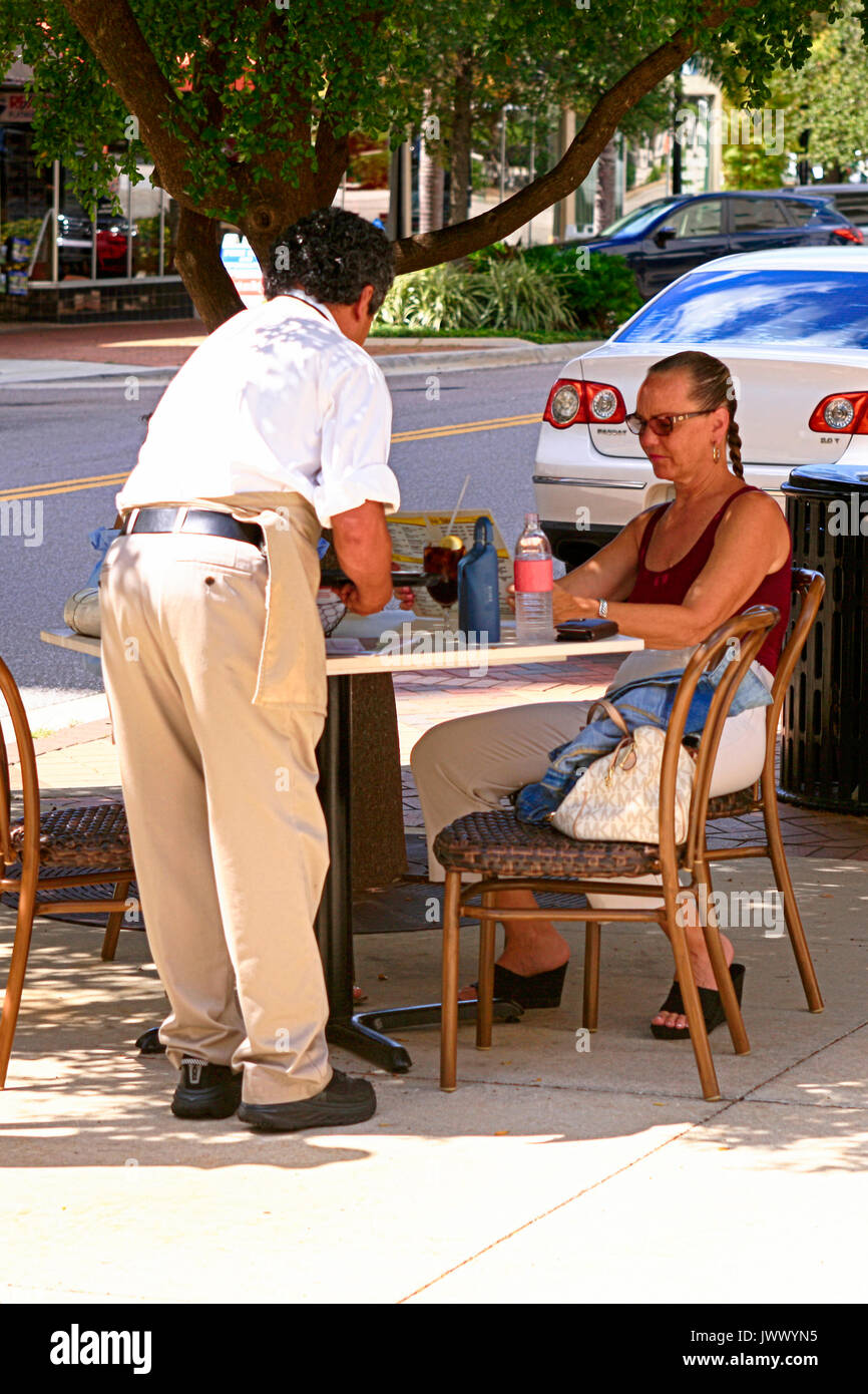 Frau, die an einem straßencafe Tabelle in Downtown Sarasota, FL, USA Stockfoto