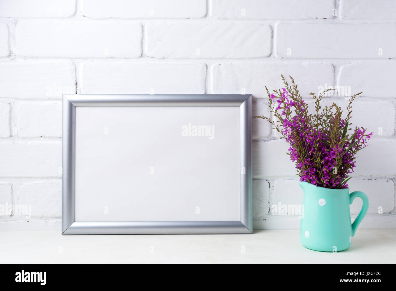Silber Landschaft frame Mockup mit kastanienbraunen lila Feld Blumen in Polka Dot Mint Green Krug Vase. Leeren Rahmen mock up für Präsentation Artwork. Tem Stockfoto