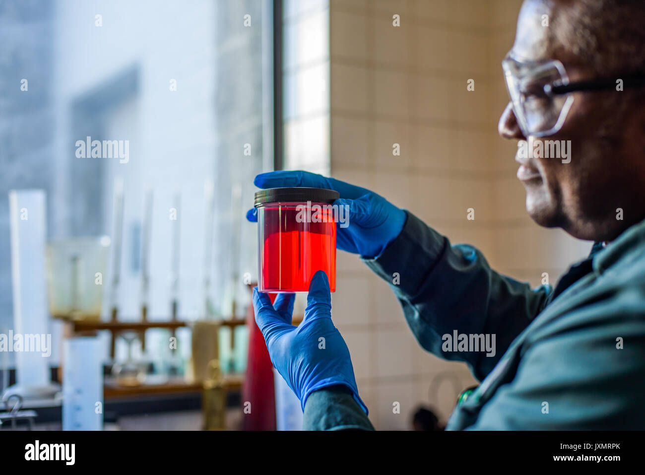 Lab Technician in Becher rot Biokraftstoff Biokraftstoff anlage Labor Stockfoto