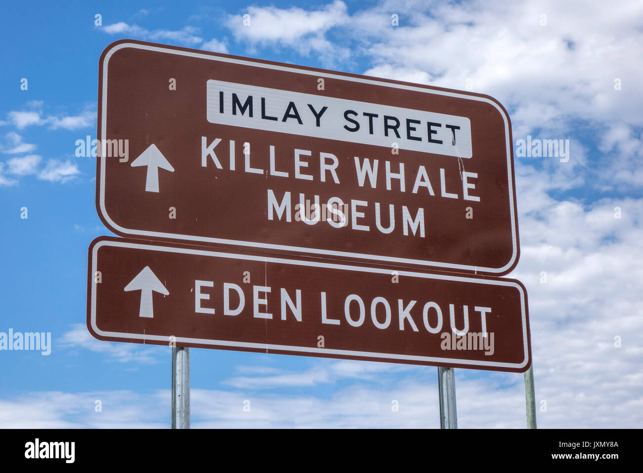 Eine Richtung Straßenschild In Eden New South Wales Australien für lokale Sehenswürdigkeiten der Killer Whale Museum und den malerischen Ozean Suche Stockfoto