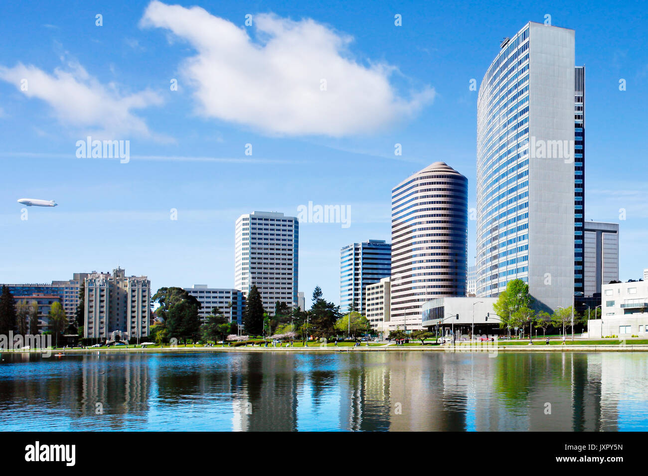 Oakland, Kalifornien downtown Lake Merritt an einem sonnigen Tag. Gebäude und Skyline im Wasser spiegelt. Horizontale Stockfoto