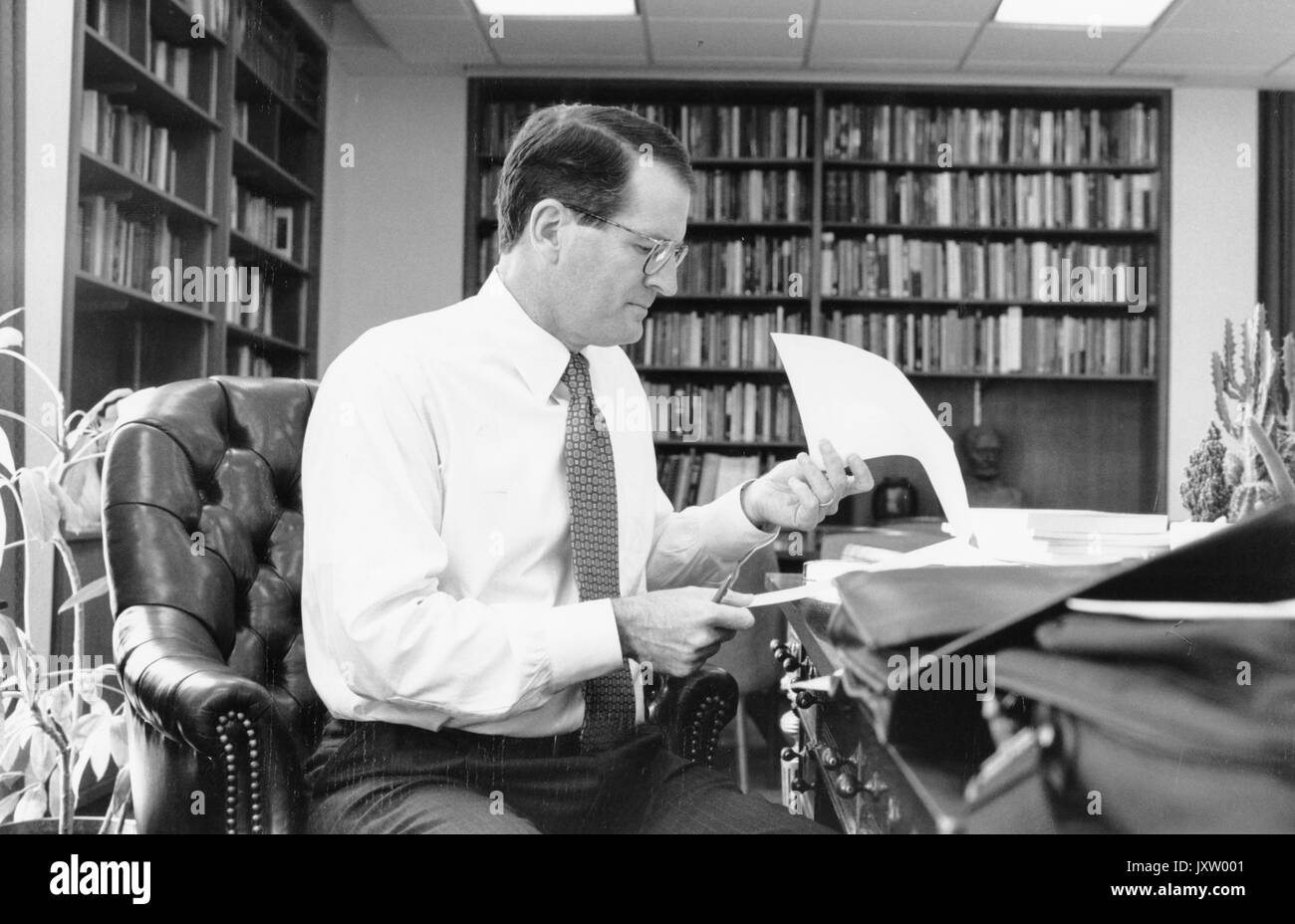 William Ralph Brody, ehrliche Foto, am Schreibtisch sitzend mit Papieren in der Hand, 52 Jahre alt, 1996. Stockfoto