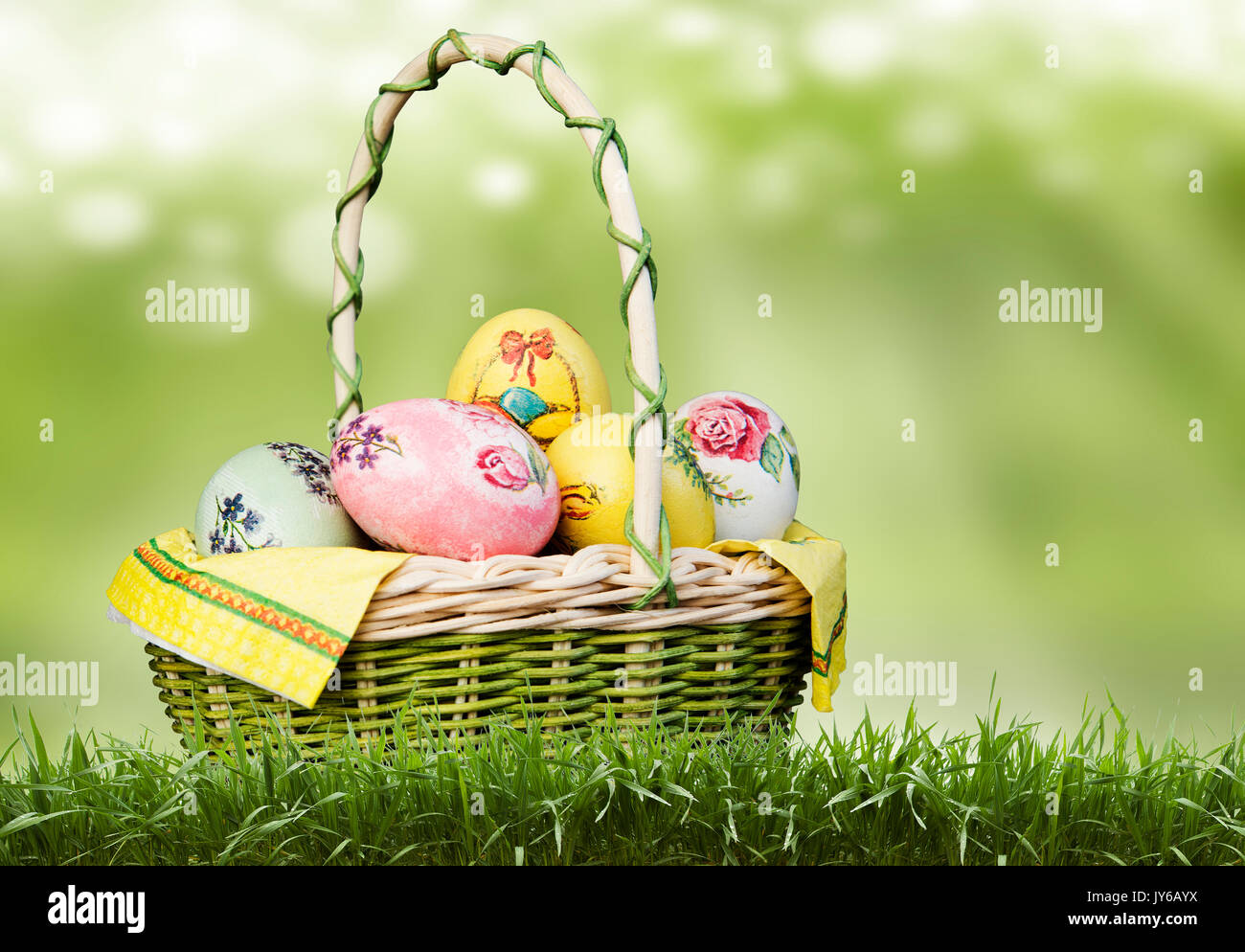 Korb mit Ostereiern auf grünem Hintergrund. Stockfoto
