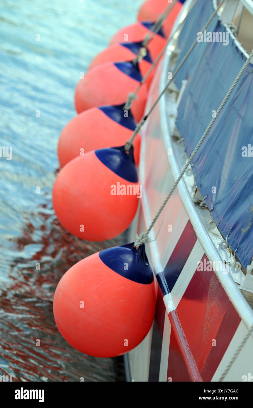 Bunte Fischerboote und Rettungsringe mit Fischen schwimmt und Netze in der Nähe upd der Decks und Ausrüstung schwimmt Kabel Netze und Boote Namen Planken und Rümpfe Stockfoto