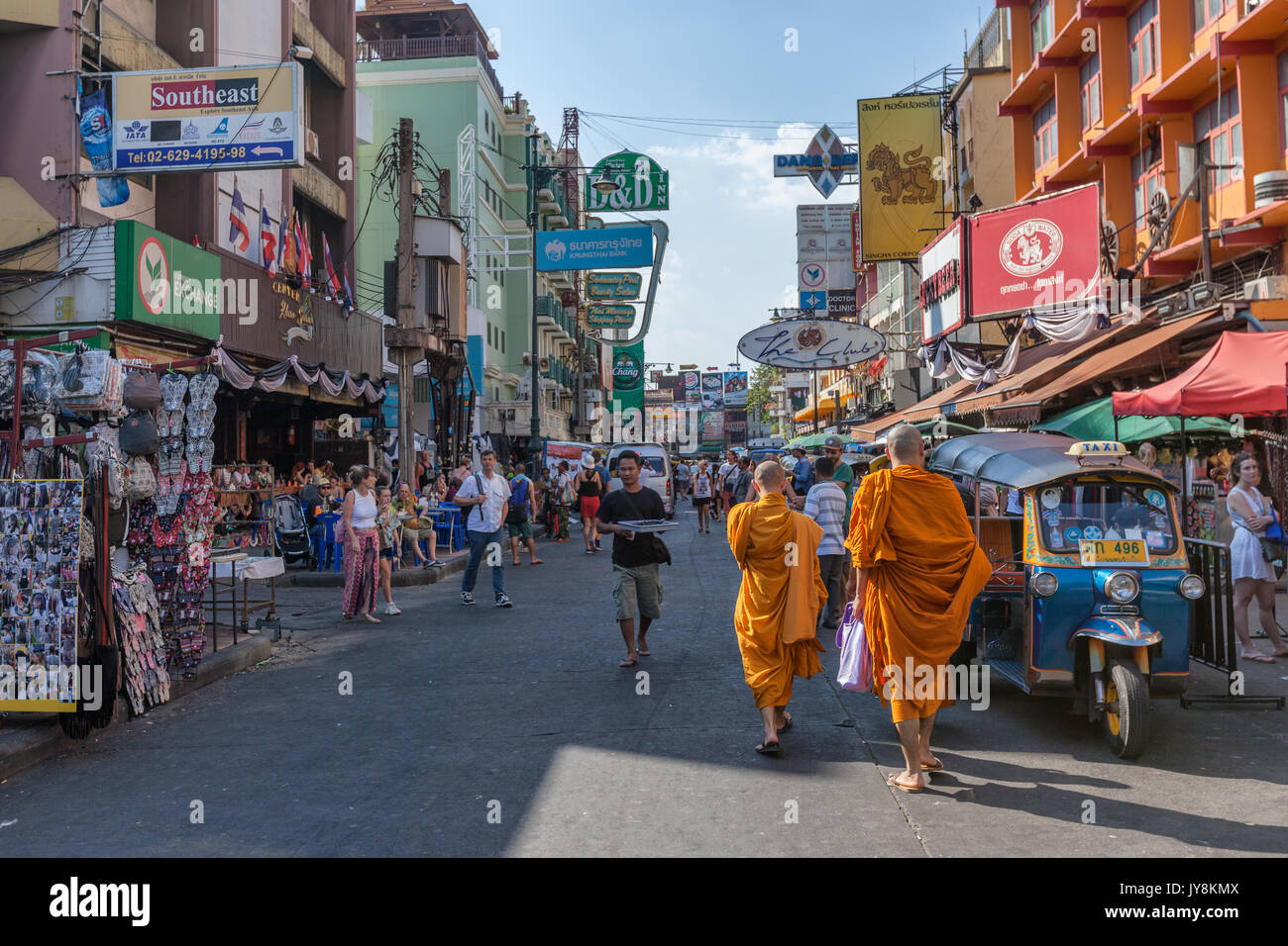 Zwei buddhistische Mönche unter der Menge von Ausländern, Essensstände und Leuchtreklamen in Khao San Road in Bangkok, Thailand Stockfoto