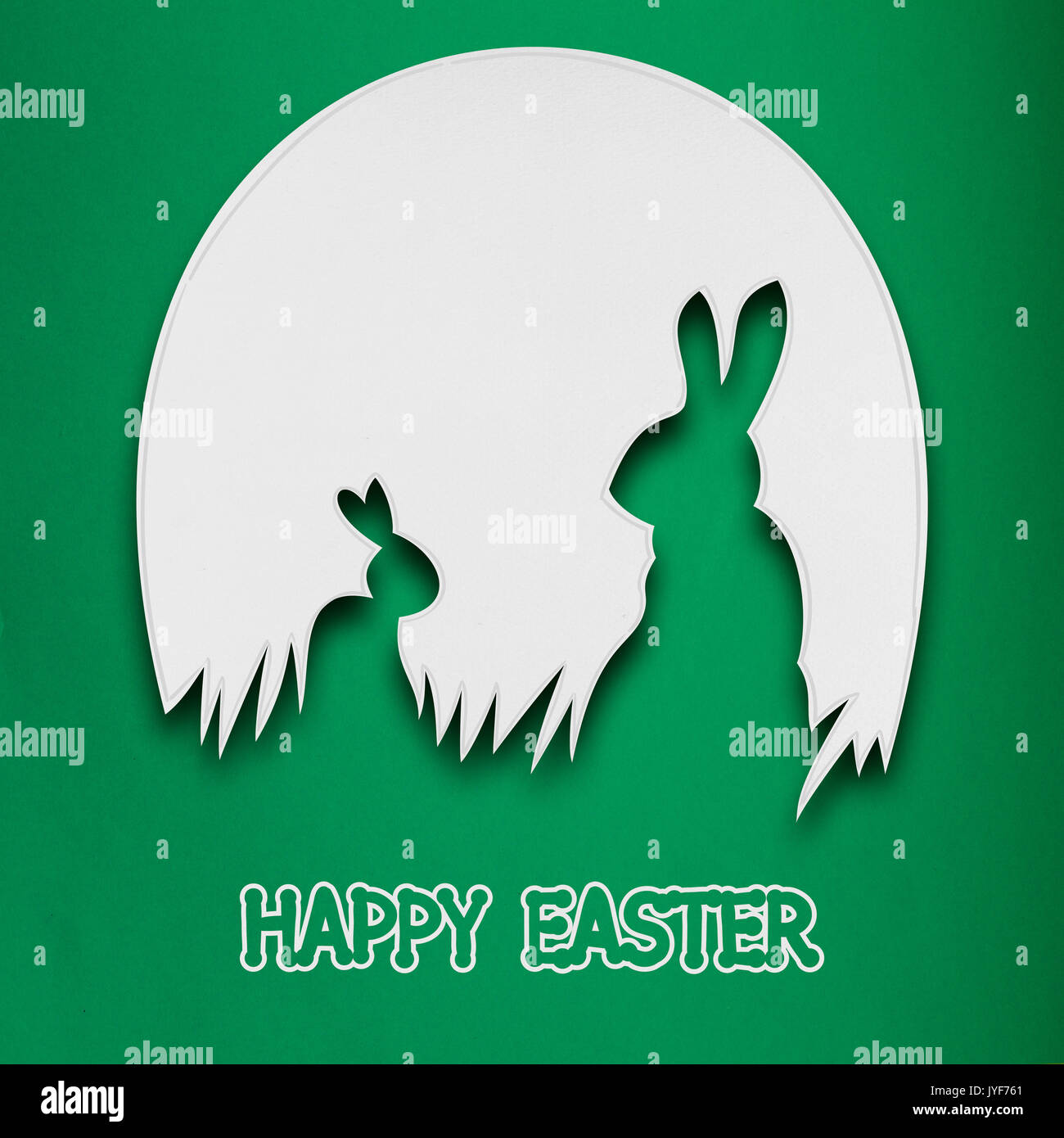 Kreative Ostern Konzept Foto von zwei Kaninchen in einem Ei hergestellt aus Papier auf grünem Hintergrund. Stockfoto