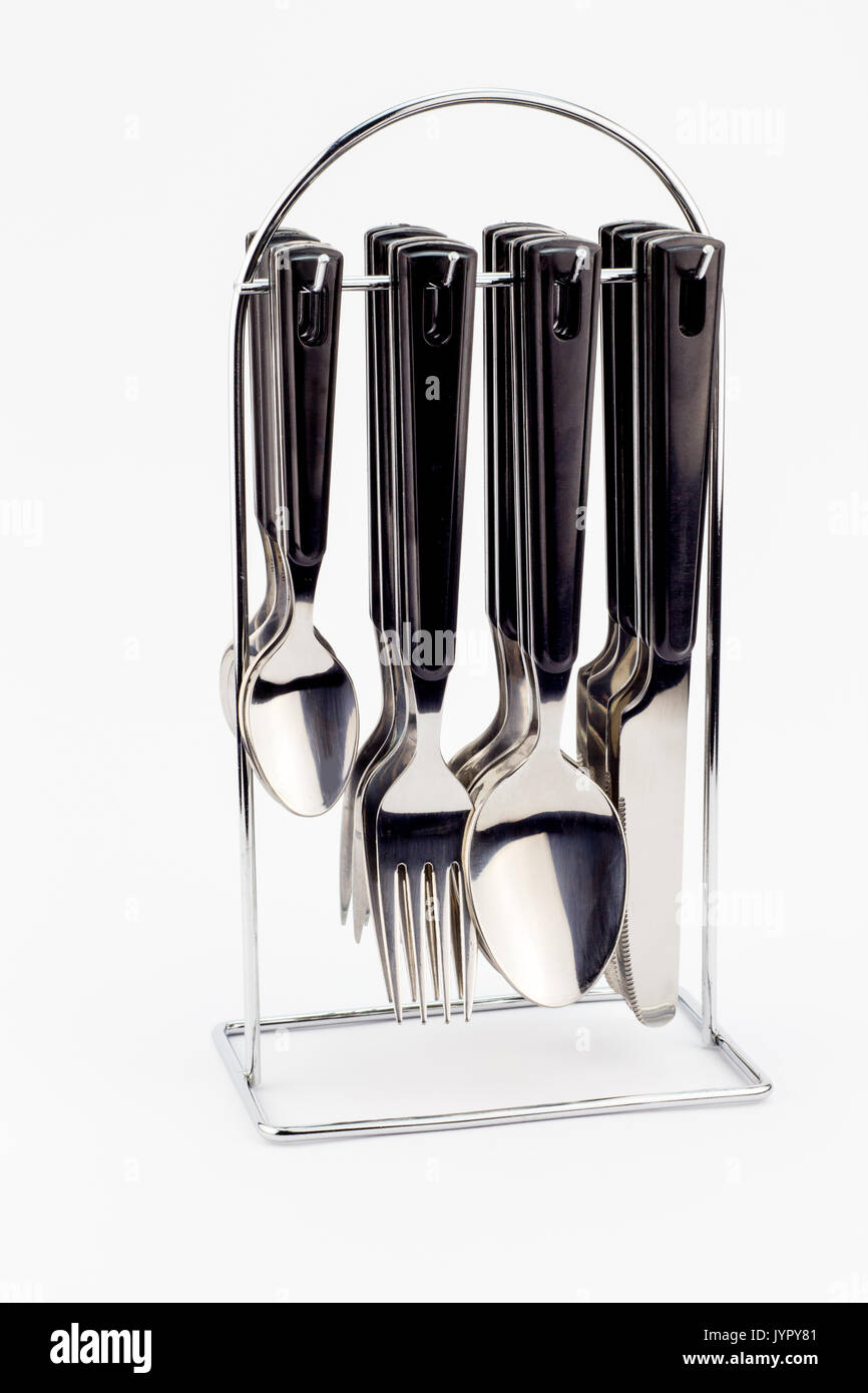 Messer, Gabel und Löffel mit schwarzen Griffen hängen auf Metallständer auf  weißem Hintergrund Stockfotografie - Alamy