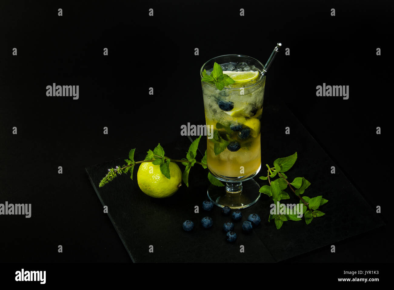 Blueberry Mojito mit Limette und Minze auf dem schwarzen Hintergrund Stockfoto