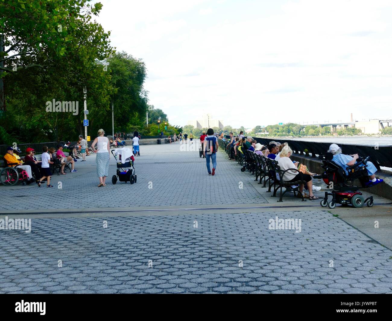 Menschen aller Altersgruppen Entspannung auf der Promenade an der Carl Schurz Park an einem Samstag Nachmittag. Upper Eastside, Manhattan, New York City, New York, USA. Stockfoto