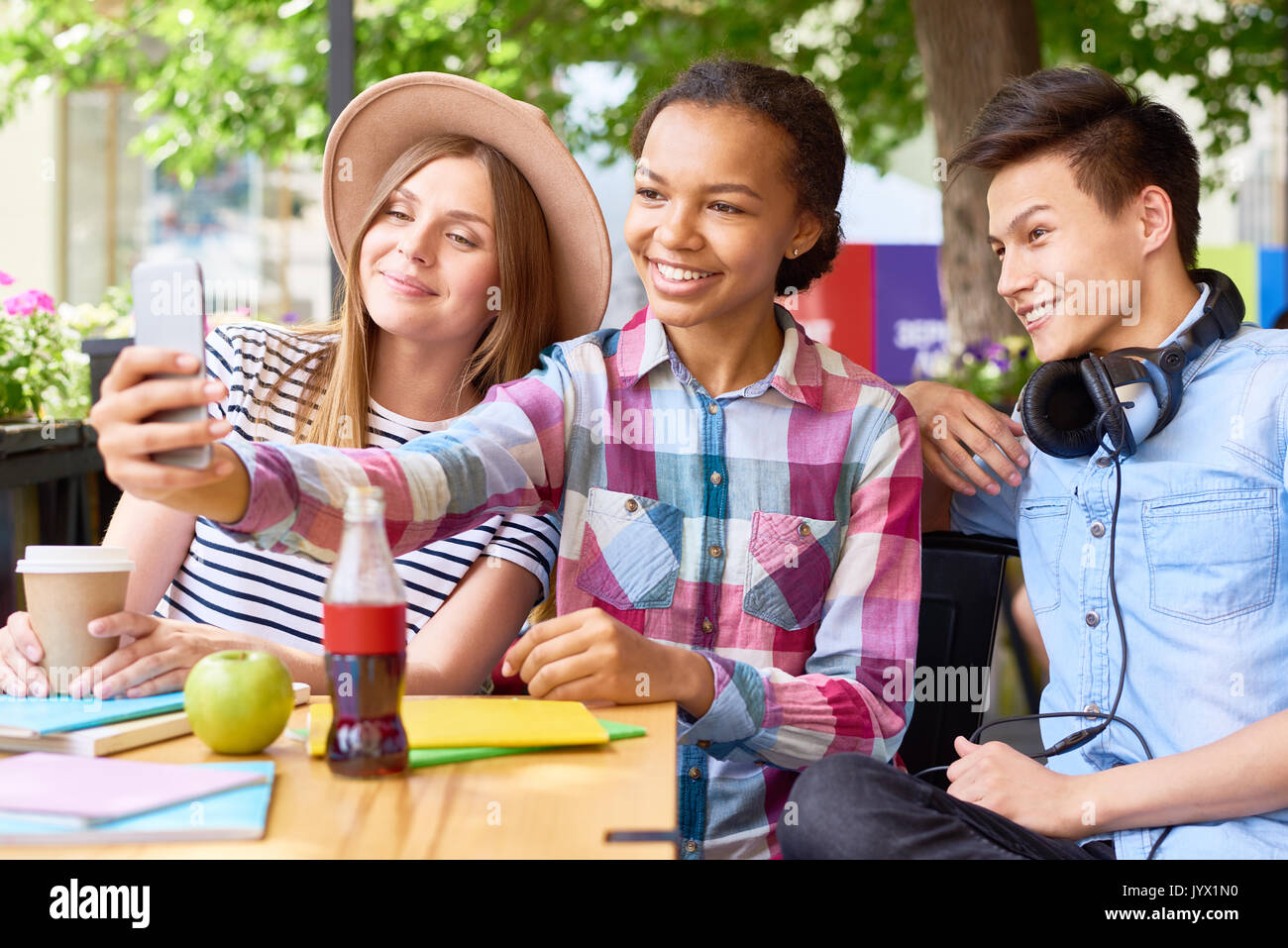 Fröhliche junge Menschen unter Selfie im Cafe Stockfoto