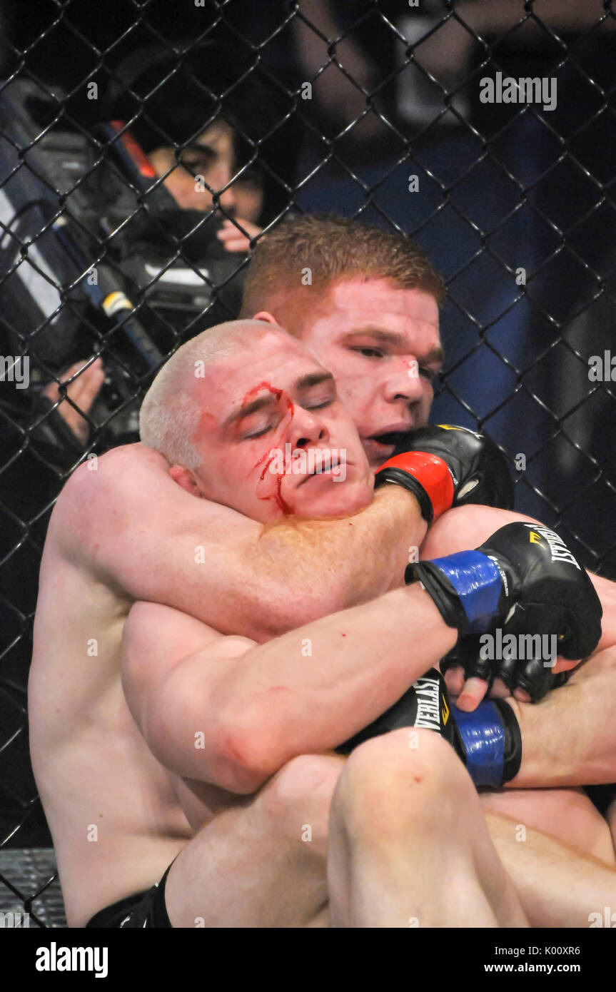 MMA Käfig Kämpfer mit einer Fläche schneiden Kämpfe selbst aus einem Strangle hold zu befreien. Stockfoto