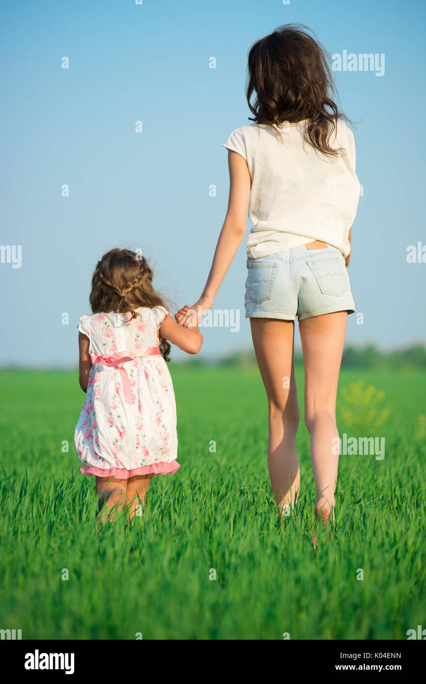 Junge Mädchen, die gerne an der grünen Weizenfeld Stockfoto
