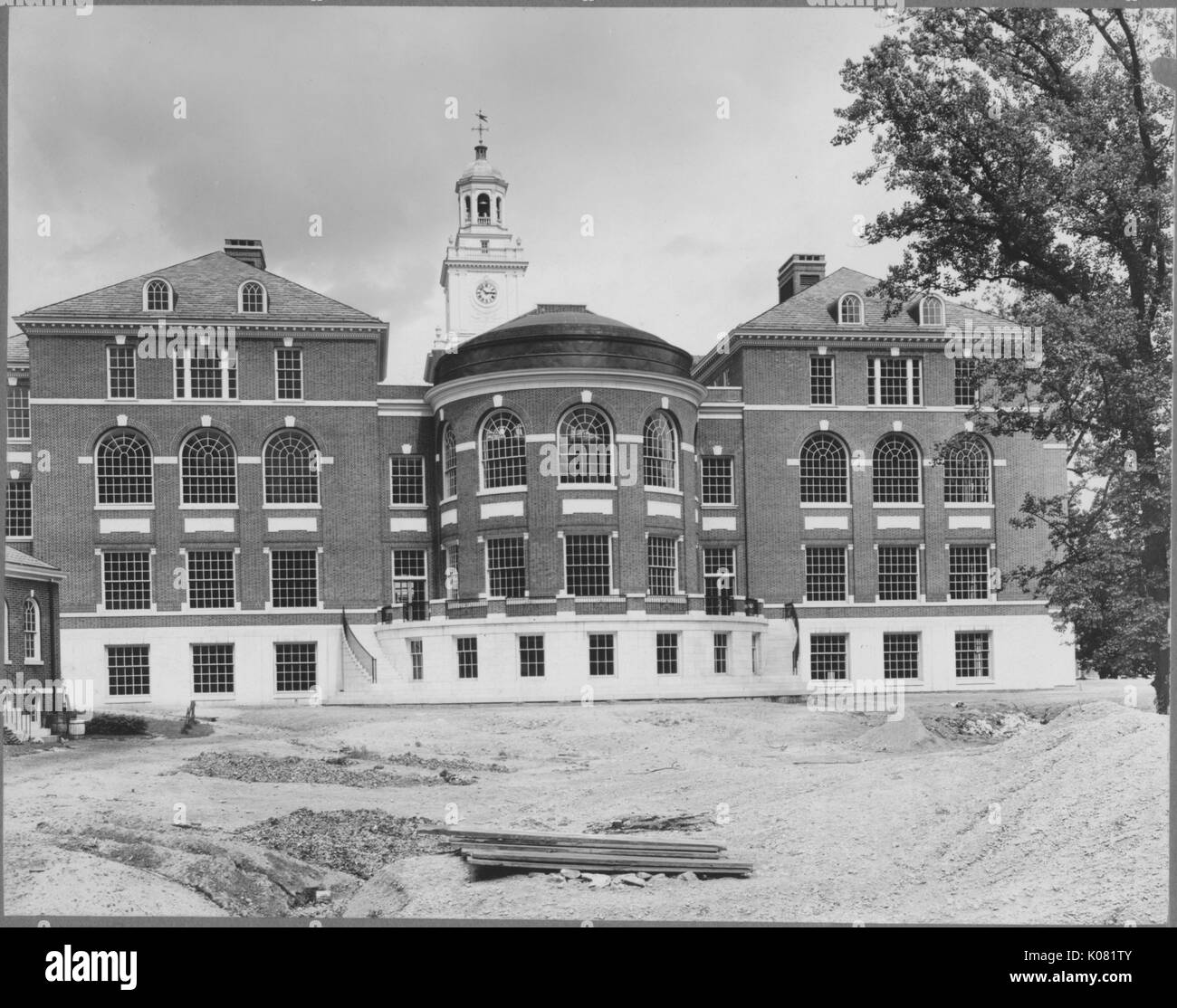 Bild des rechten Flügels der Gilman Hall mit der freien Landschaft im Bau, mit dem Glockenturm oben gezeigt, Gilman Hall mit seinen großen Fenstern, Ziegel, Inlay, und Marmorsockel, United States, 1950. Dieses Bild wird von einer Reihe dokumentieren den Bau und den Verkauf von Wohnungen in der Roland Park/Guilford Nachbarschaft von Baltimore, einer Straßenbahn Vorort und eines der ersten geplanten Gemeinschaften in den Vereinigten Staaten. Stockfoto