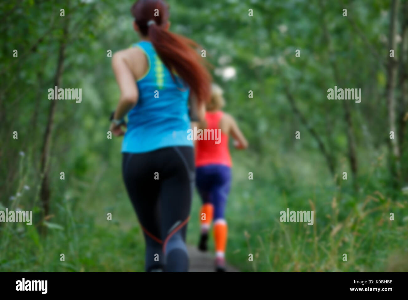 Zwei Sportler in Wald läuft Stockfoto