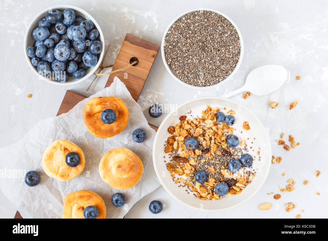 Müsli mit Joghurt und mini Käsekuchen mit Heidelbeeren zum Frühstück. Stockfoto