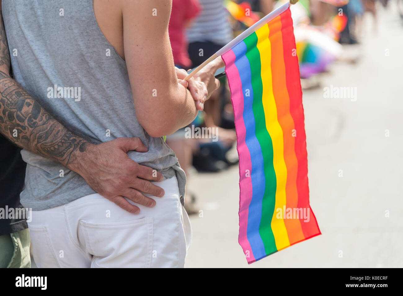 Montreal, Kanada - 20 August 2017: Rückseite des männliche homosexuelle Paar hält ein gay Regenbogen Flagge in Montreal Gay Pride Parade Stockfoto
