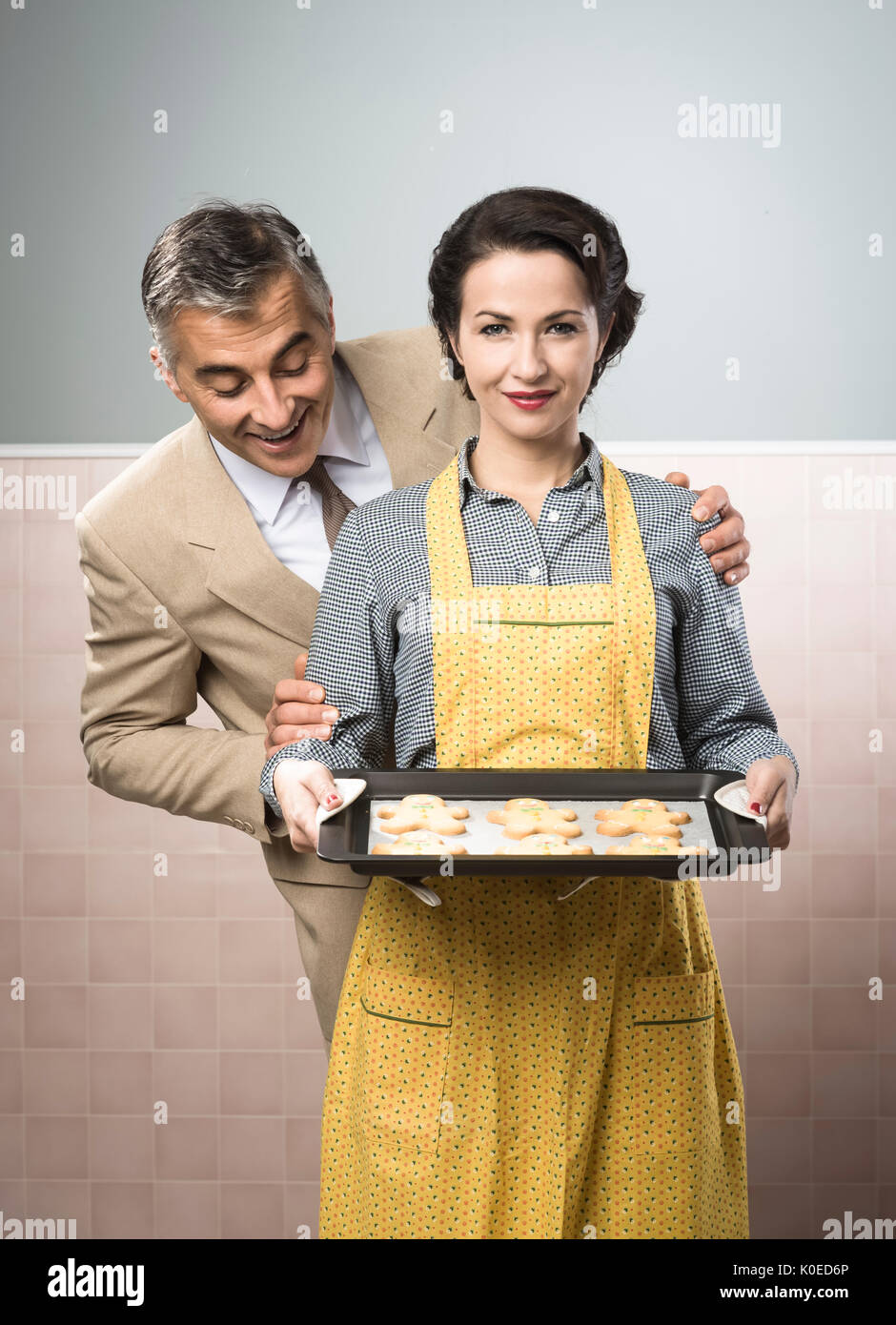 Vintage glückliche Paar Lächeln auf den Lippen, dient sie nach Hause gemachte Lebkuchenmänner cookies Stockfoto