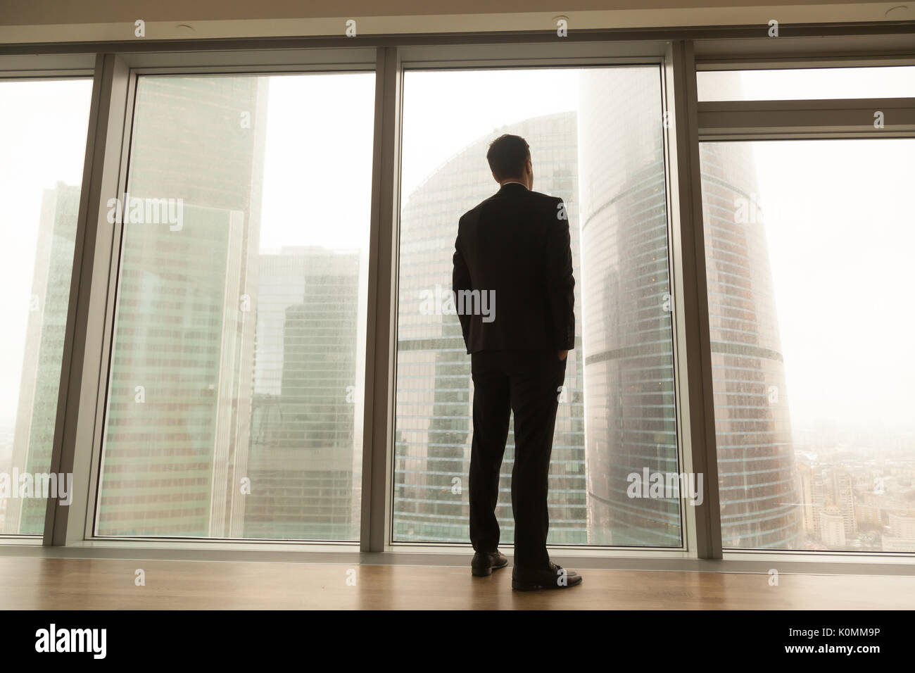 Unternehmer stehen in der Nähe der Fenster in voller Länge im City suchen, Ba Stockfoto