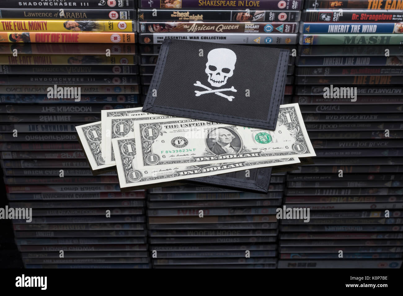 Gestapelte DVD-Filme & Schwarz pirate Portemonnaie mit uns einen Dollar Bills - für Urheberrecht & IP-Verletzung - US-chinesischen Handelsbeziehungen, US-China trade Krieg. Stockfoto