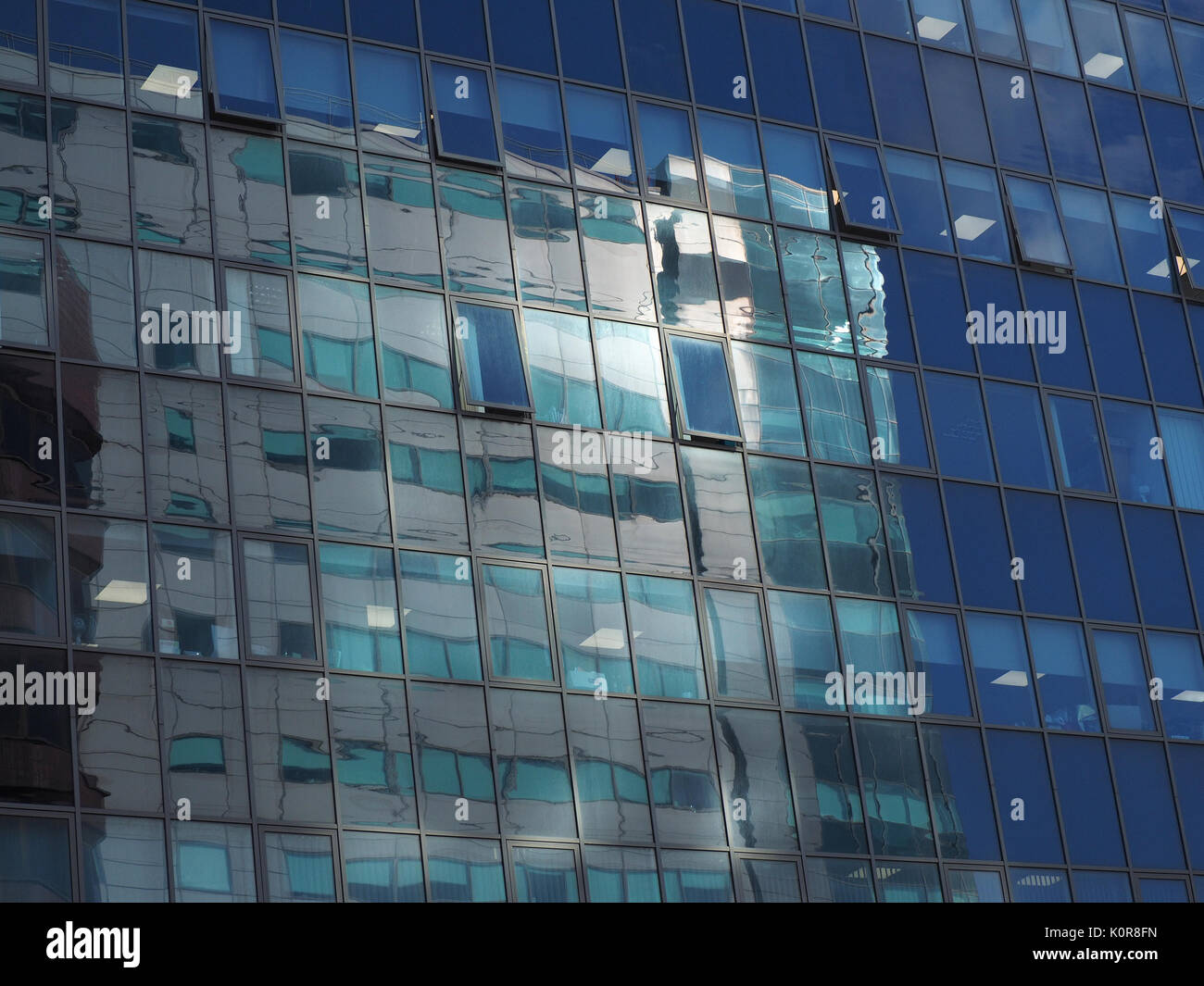 Reflexionen der Sonne auf blau getönten Scheiben aus glasierten mehrstöckigen Bürogebäude in Sheffield, South Yorkshire, England, Großbritannien Stockfoto