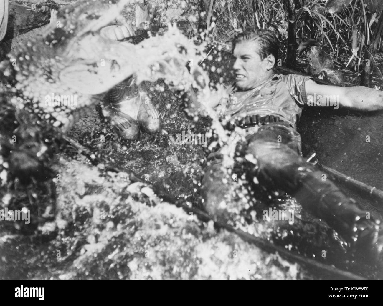 Filmstill eines unbekannten Schauspielers, der in einem Gewässer kämpft, aus dem Film Stranger on the Prowl, 1952. Stockfoto