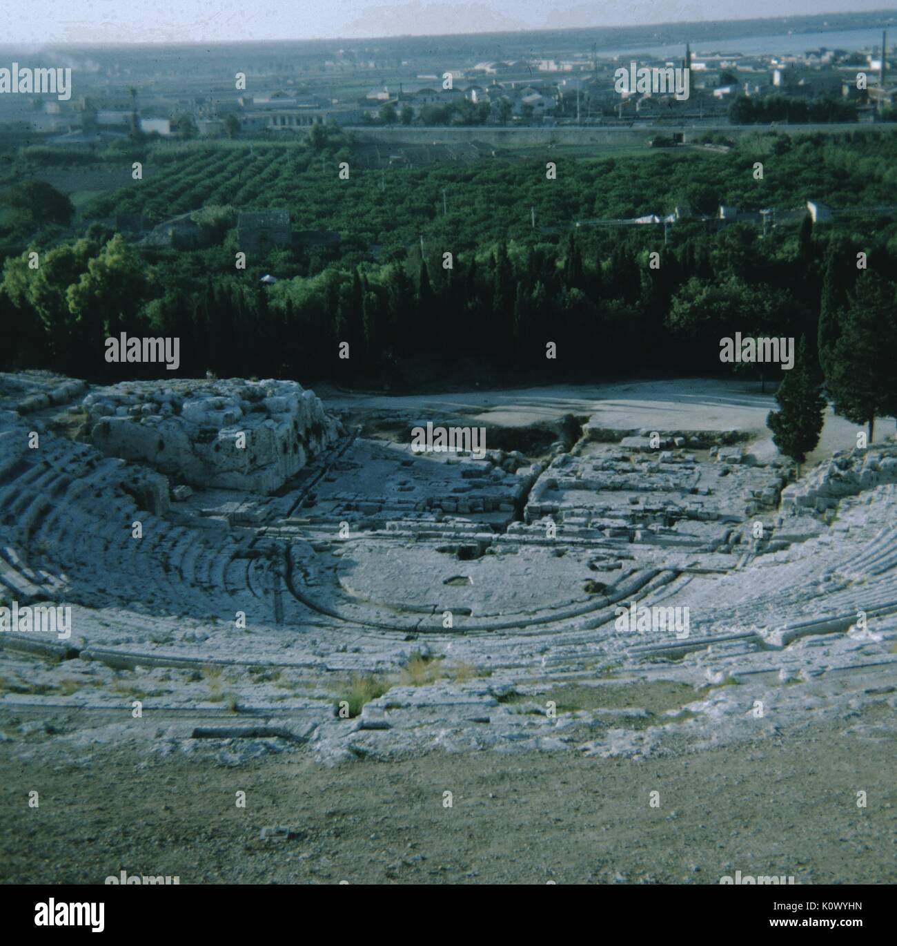 Ruinen einer Römischen Amphitheater, gesehen von der Oberseite der Theater, eine Stadt und eine Traube Weinberg im Hintergrund, Athen, Griechenland, 1971. Stockfoto