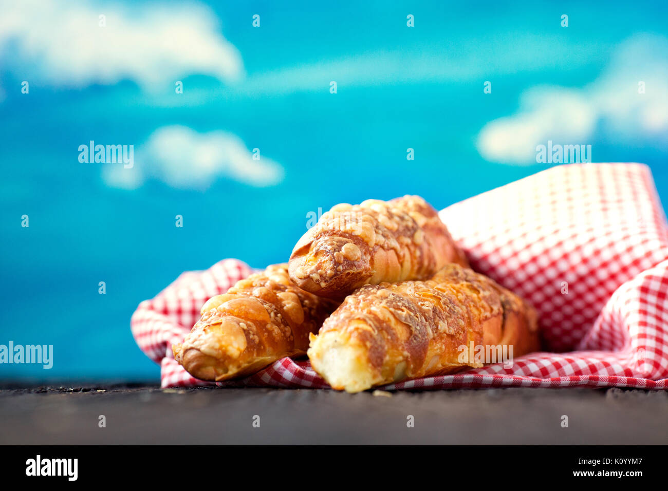 Frisch gebackenen Käse Brötchen auf hölzernen Hintergrund mit blauen Himmel im Hintergrund. Stockfoto