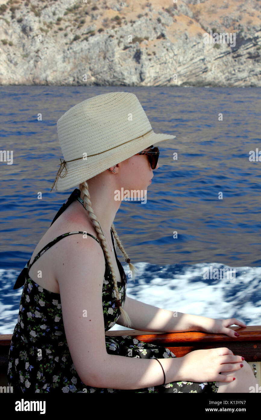 Blick auf die junge Frau auf Boot tragen Sonnenhut Stockfoto