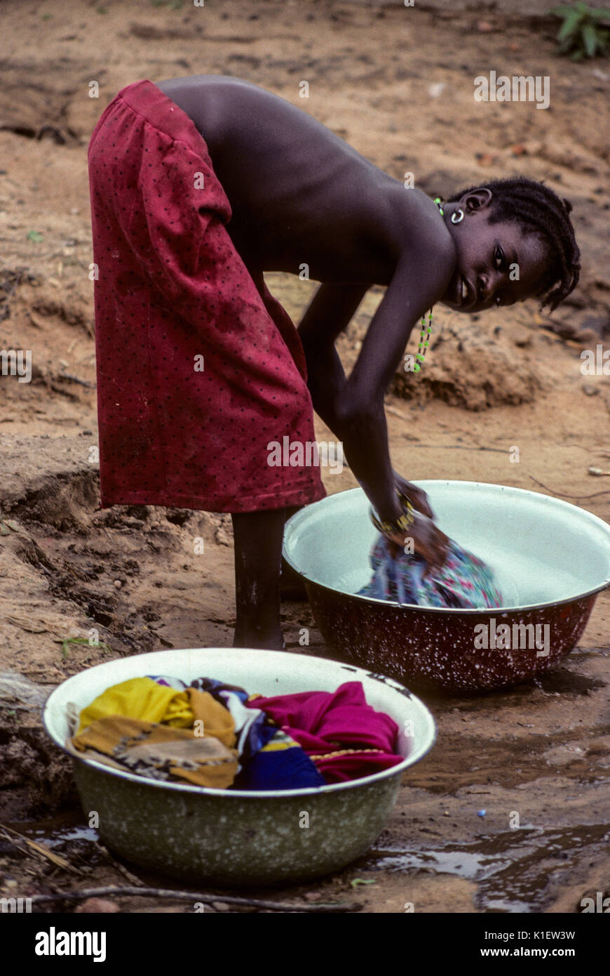 Niger, Dan Gaya Village, West Afrika, junge Frau Wäsche Waschen in einem Waschbecken. Stockfoto
