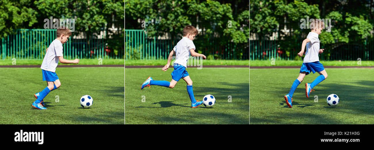 Junge Fußball-Spieler läuft mit dem Ball auf dem grünen Rasen des stadiumм Stockfoto