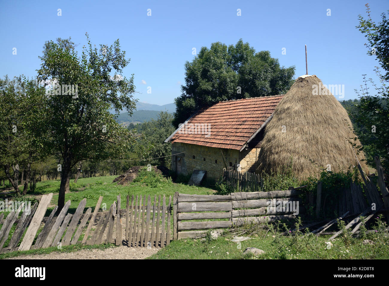 Traditionelle Ferienhaus und Haystack in Bergdorf, in der Nähe von Foca, Bosnien und Herzegowina, Juli 2014. Stockfoto
