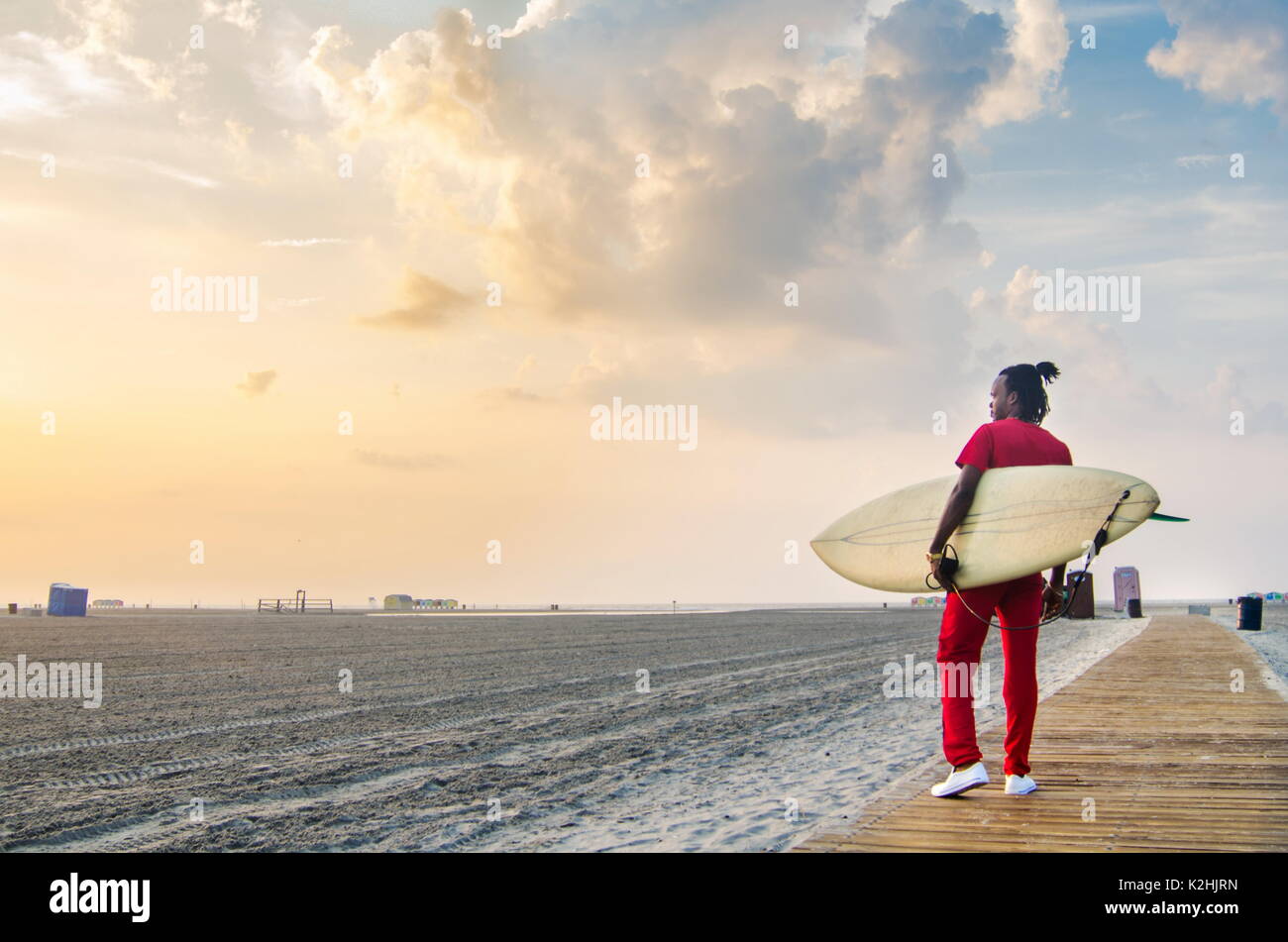 Junge Menschen auf dem Weg zu Meer mit einem Surfbrett Stockfoto